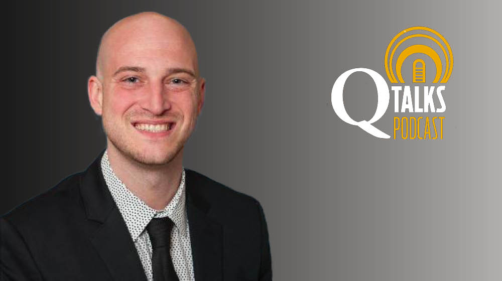 Zach Binkley professional headshot with the Q Talks Podcast logo against a gray background.